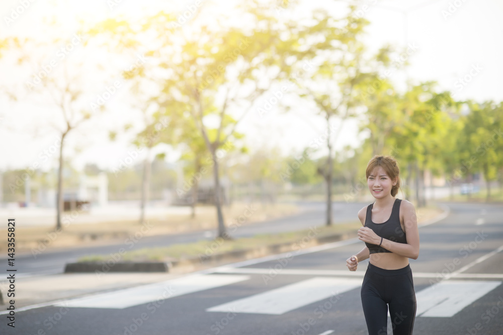 young sporty woman running in park