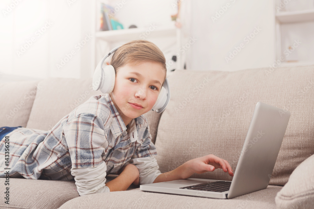 Teenage boy enjoying music in headphones at home Teenage boy enjoying music in headphones at home