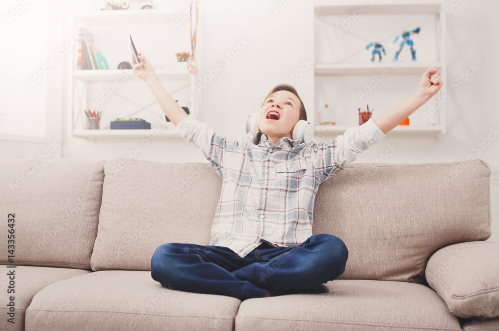 Teenage boy play games on sofa at home Teenage boy play games on sofa at home
