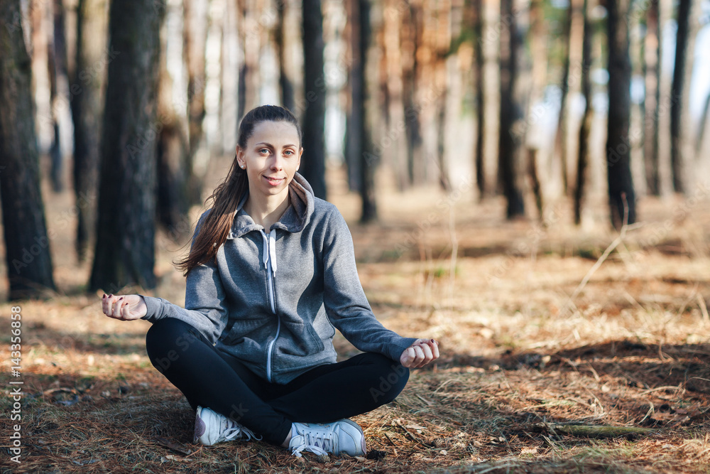 Young woman doing yoga outdoors in the forest Young woman doing yoga outdoors in the forest