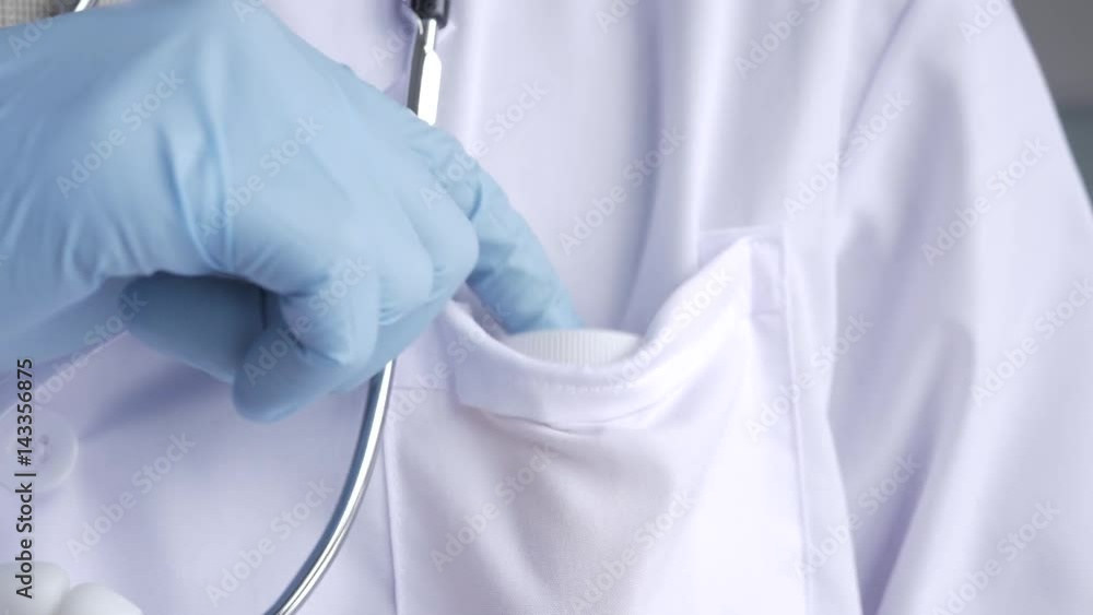 Doctor putting back in his pocket a pill container. Doctor putting back in his pocket a pill container.