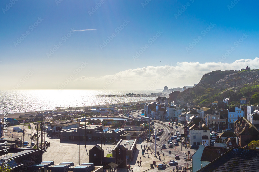 People and traffic on a sunny day in the historic town of Hastings in East Sussex, England