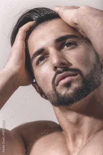 Dreamy male look. Bearded face of strong man. Dream or thoughts. Beautiful face of sexy guy. Attractive man close up. Brown eyes and black hair white men photo