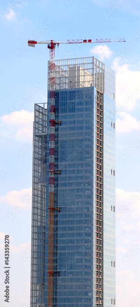Fototapeta premium very tall skyscraper under construction made of glass and steel