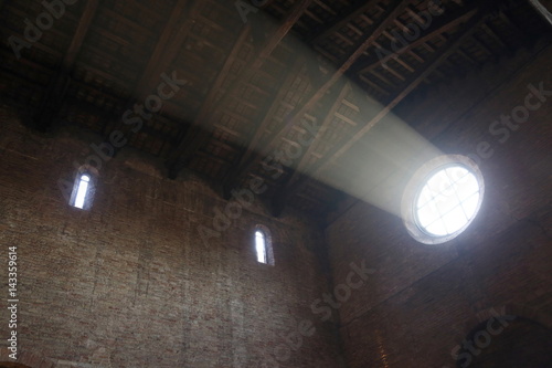 atmospheric beam of light coming from the rose window