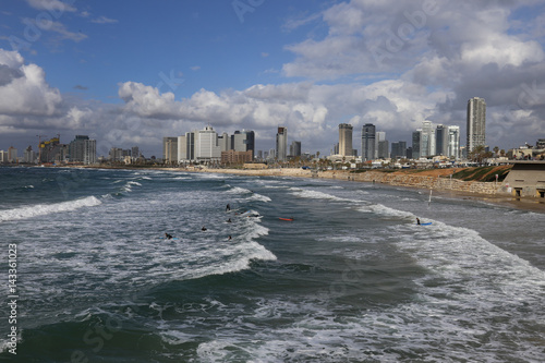 View of the waterfront with modern luxury hotels, beach and surfers from old Jaffa. Mediterranean Sea, Tel Aviv, Israel.