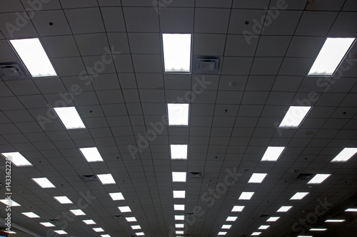 Lights in long line on ceiling of hall