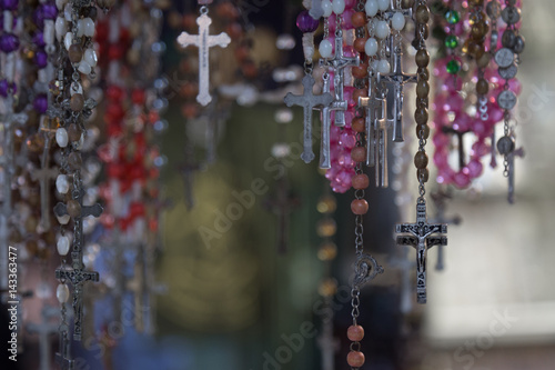 Christian cross and rosary colorful background.