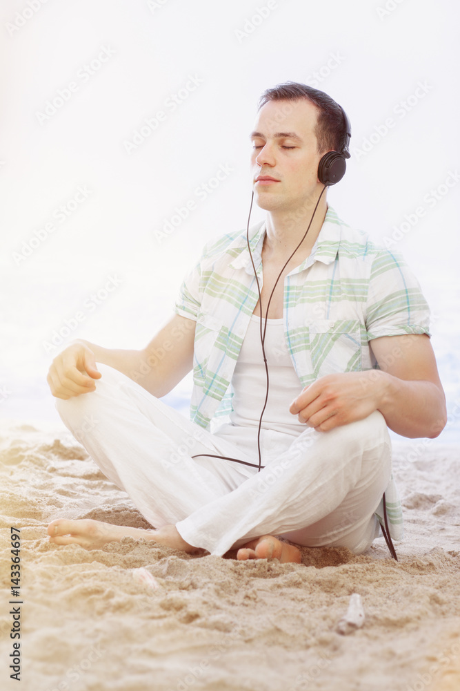 A Day at the Beach - Taking a moment to meditate, with headphones and crossed legs: Relaxation
