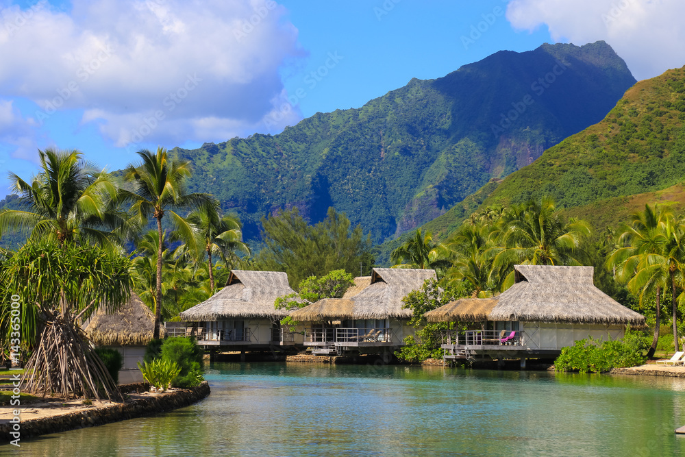 Island of Moorea in the French Polynesia with her exuberant vegetation, lagoon, bungalows and mountains.