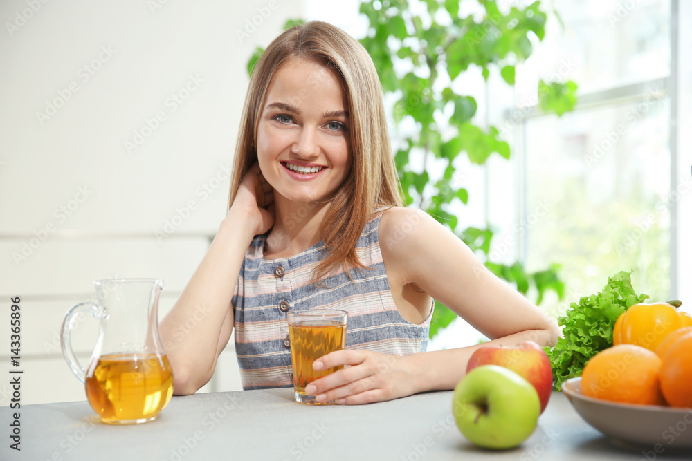 Young woman making fresh juice in the kitchen Young woman making fresh juice in the kitchen