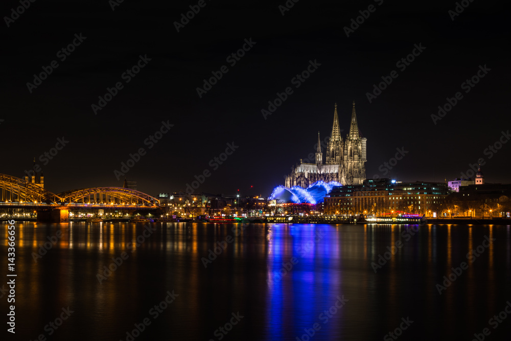 View to the Skyline of Cologne at Night with the Cologne Cathedral, the Musical Dome and the river Rhine.