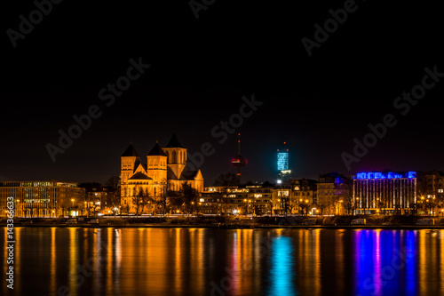Skyline of Cologne at night with the Basilica of St. Cunibert  the Cologne Tower  the Colonius and the river Rhine