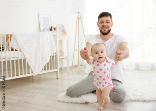 Father sitting with cute ba...
