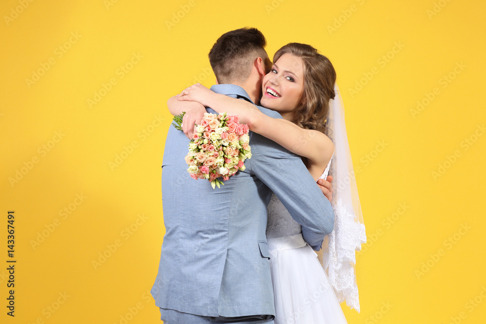 Happy wedding couple on color background Happy wedding couple on color background