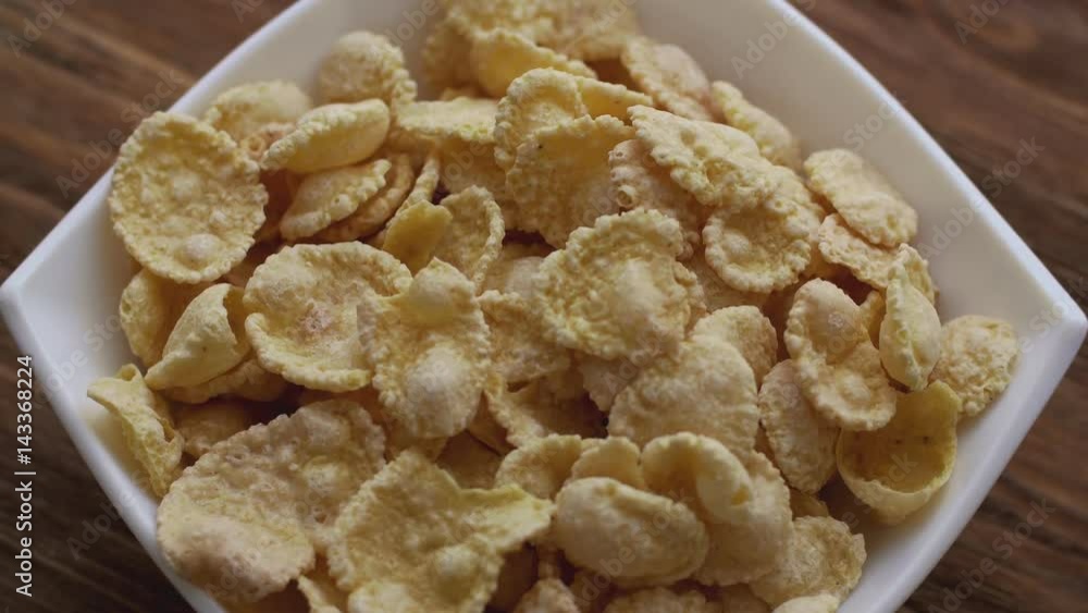 Corn flakes in white bowl. Slide down Corn flakes in white bowl. Slide down
