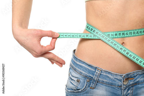 Diet concept. Young woman with measuring tape on white background