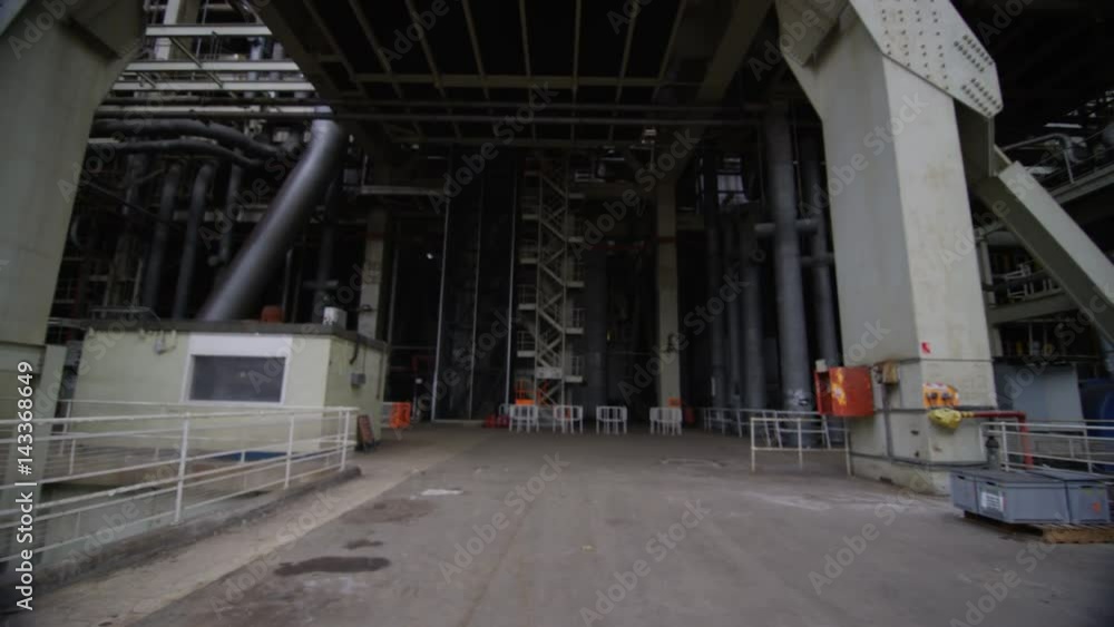 Team of engineers in power station, wide shot of workers & building structure Team of engineers in power station, wide shot of workers & building structure