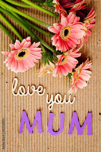 Fototapeta Naklejka Na Ścianę i Meble -  Mother's Day message with flowers on corrugated cardboard background - Mum
