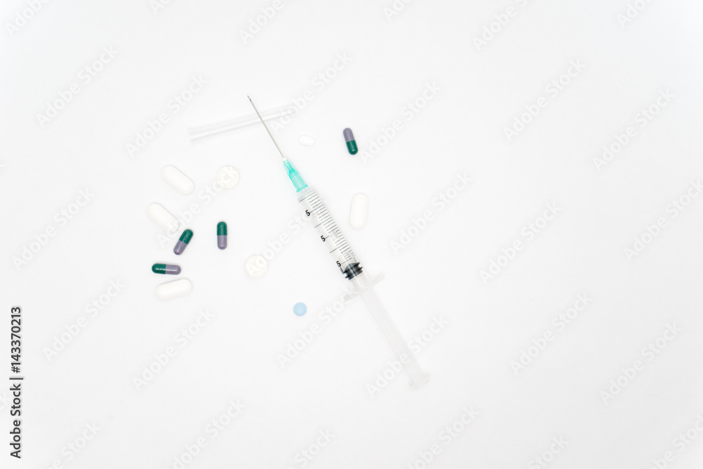 Medical syringe and pills isolated on white background Medical syringe and pills isolated on white background