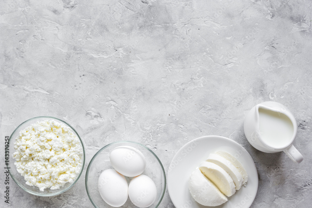 Fototapeta premium monochrome concept with dairy products on stone table top view mock up