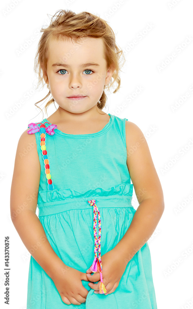 Beautiful little tanned girl in a blue dress. Beautiful little tanned girl in a blue dress.