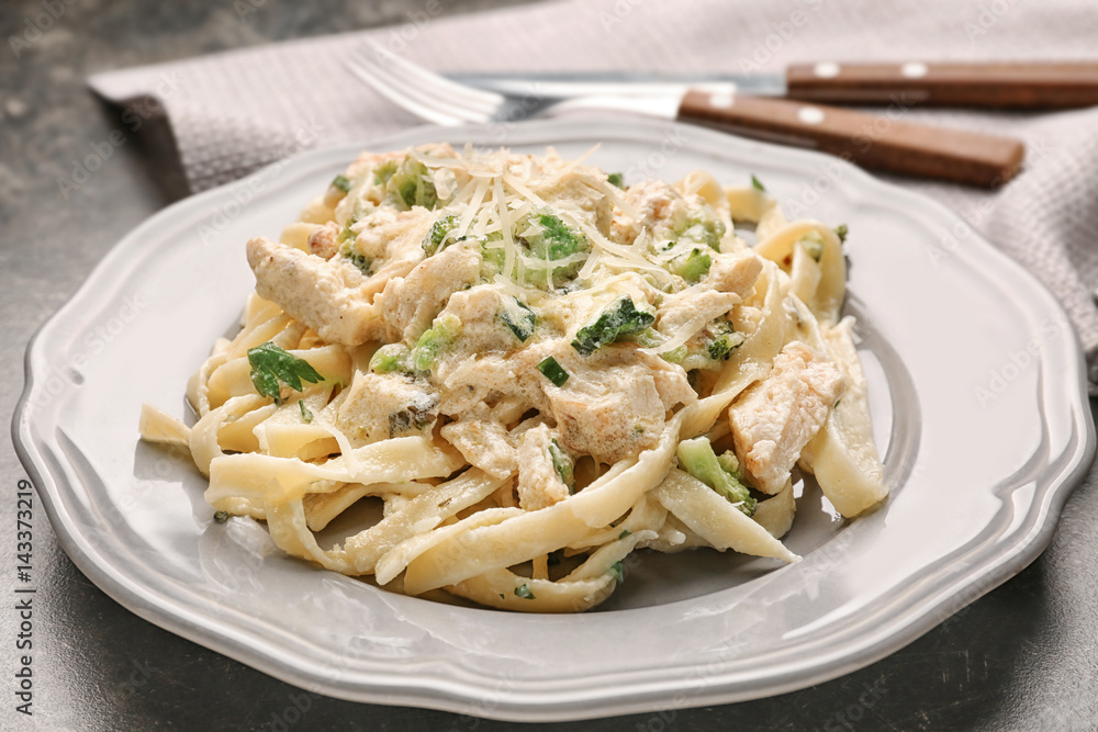 Plate with delicious Chicken Alfredo on table