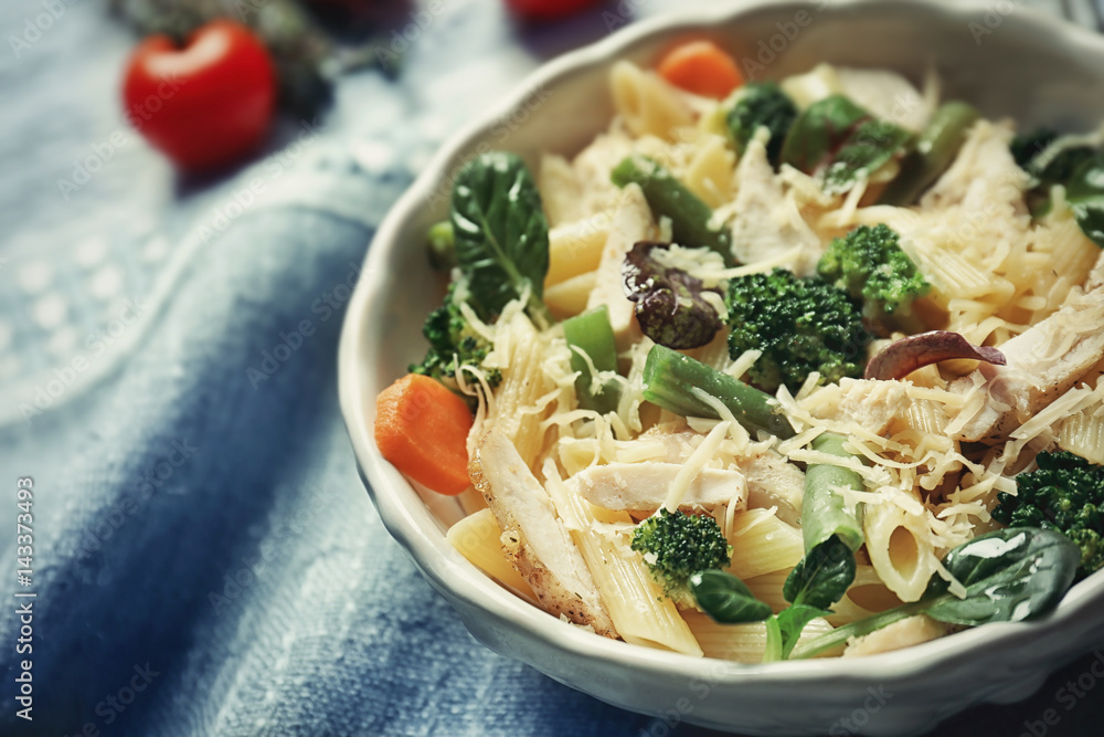 Bowl with tasty chicken and noodles on table Bowl with tasty chicken and noodles on table