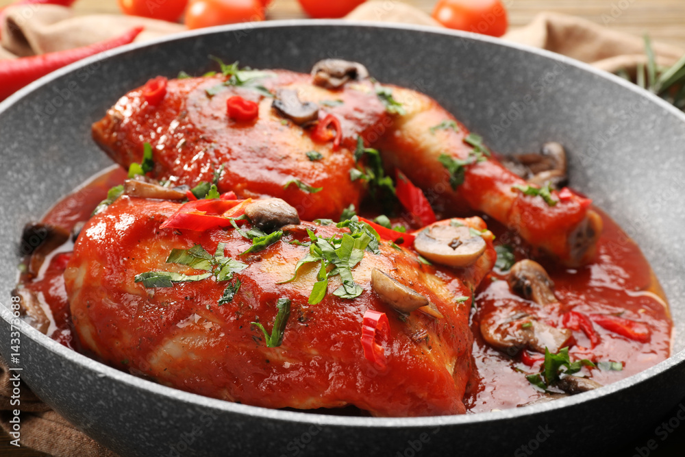 Frying pan with chicken cacciatore, closeup Frying pan with chicken cacciatore, closeup