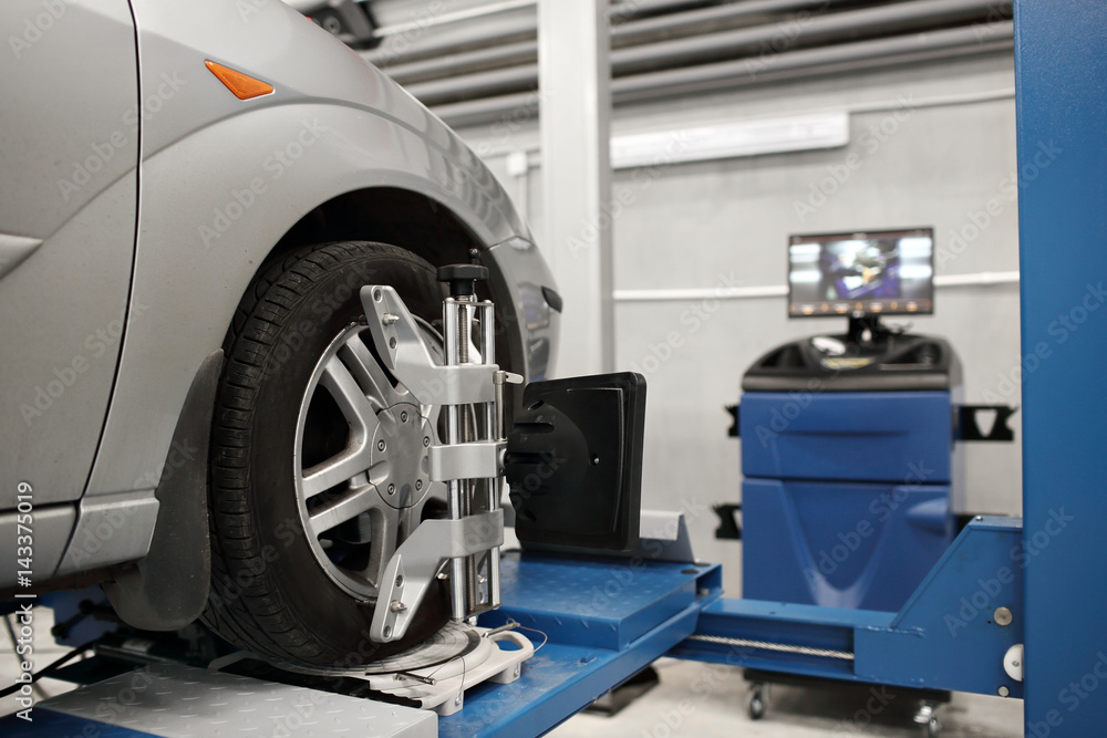 Grid sensor sets mechanic on auto. Car stand with sensors wheels for alignment camber check in workshop of Service station. Grid sensor sets mechanic on auto. Car stand with sensors wheels for alignment camber check in workshop of Service station.