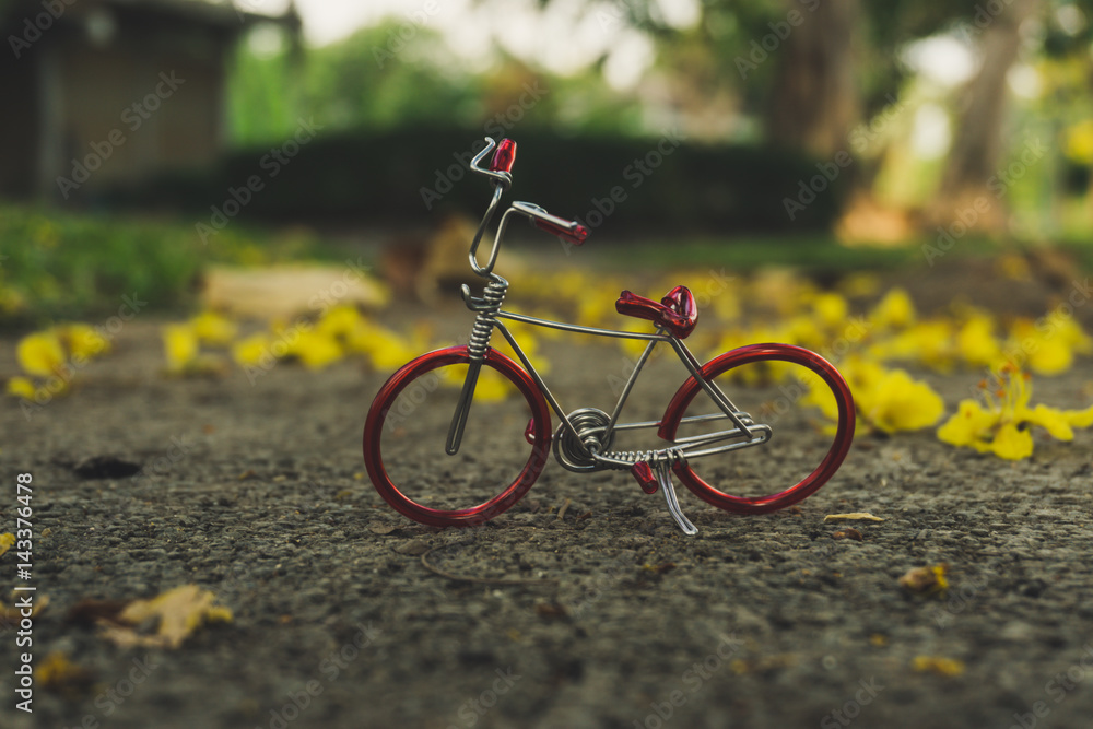 Red bicycle on beautiful yellow flower background.