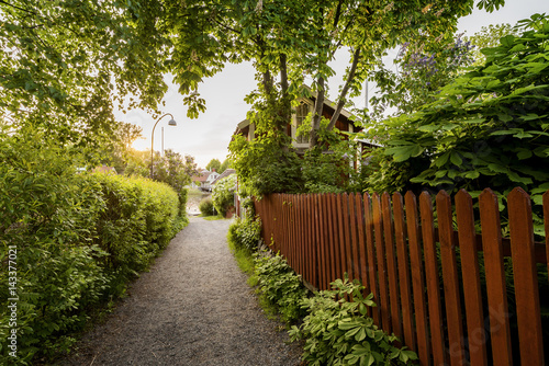 Sweden, Stockholm Archipelago, Uppland, Vaxholm, Wooden fence along footpath photo