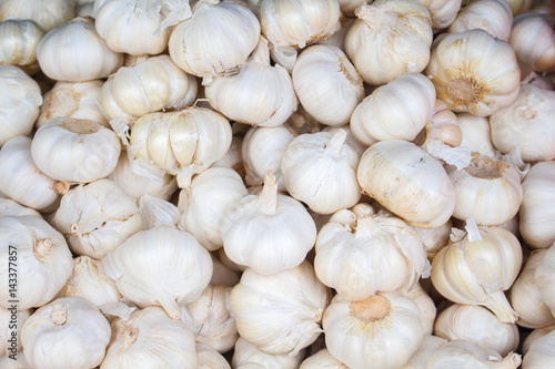 White garlic on the market. Fresh garlic harvested from the garden for sale.