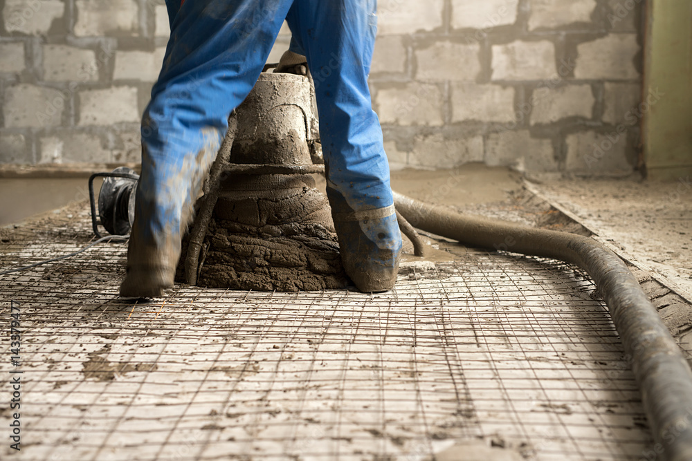 Worker making cement screed on the floor view Worker making cement screed on the floor view