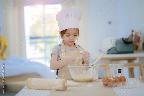 little girl cooking bread practice