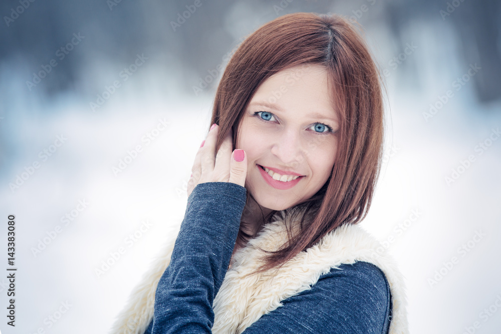 Portrait of young woman with smile in the winter forest Portrait of young woman with smile in the winter forest