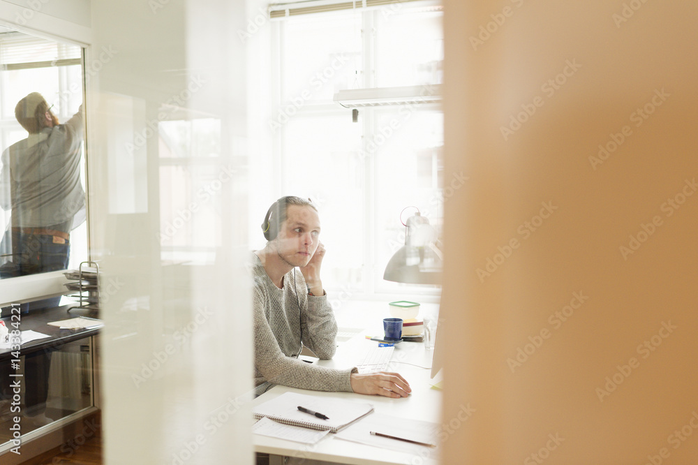 Sweden, Young men working in office Sweden, Young men working in office