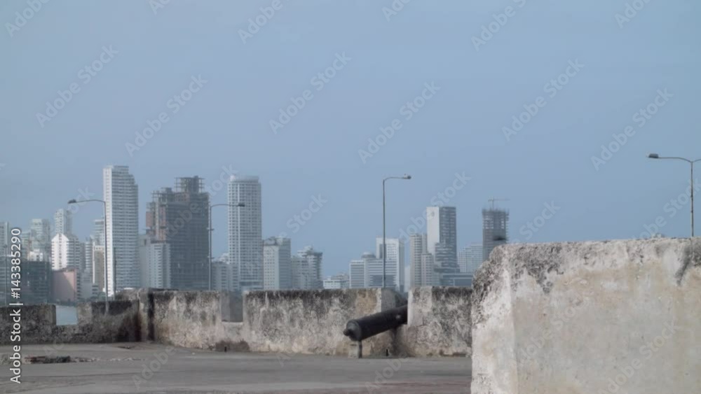 Wall with cannon on background buildings Wall with cannon on background buildings