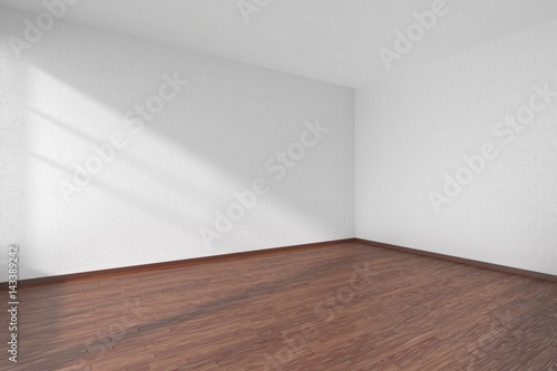 Empty room with dark parquet floor and textured white walls