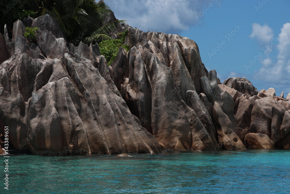 Granite Rocks of St. Pierre Island close Praslin Island, Seychelles / Beautiful scenery with blue Indian Ocean and red granite rocks.