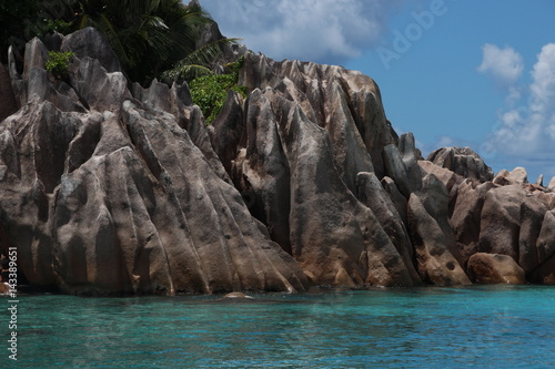 Granite Rocks of St. Pierre Island close Praslin Island, Seychelles / Beautiful scenery with blue Indian Ocean and red granite rocks.