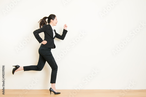 Young businesswoman with running on white background