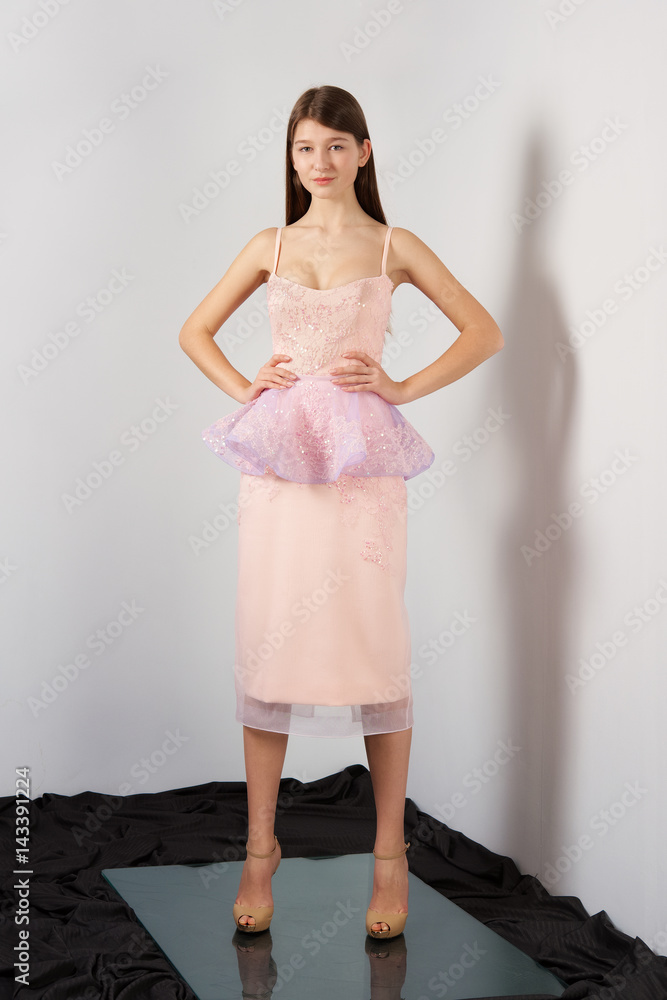 Fototapeta premium Attractive fashion model in festive dress with lace Basque posing