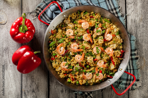 Fotografija Traditional seafood paella with shrimp, fish and chicken seved i