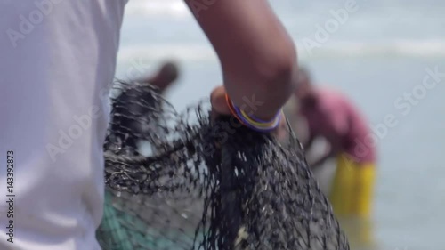 Fishermen with nets on the seashore