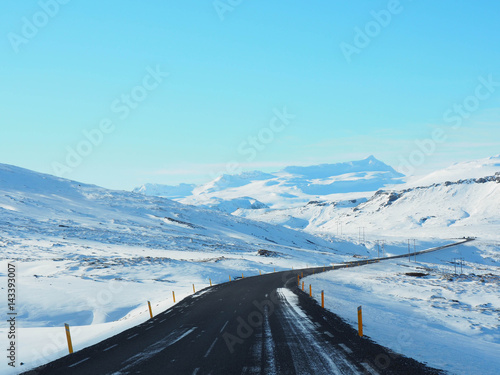 Wallpaper Mural Winter road with mountain on the side of the road covered with snow. Sunny day and clear blue sky Torontodigital.ca