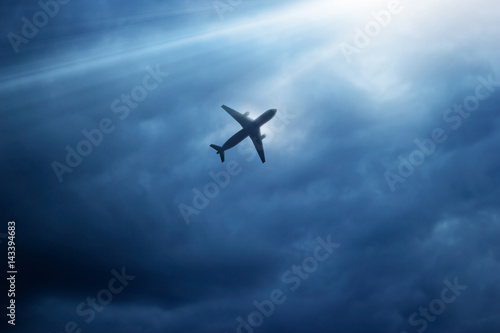 Airplane in dark blue sky and cloud in the strom