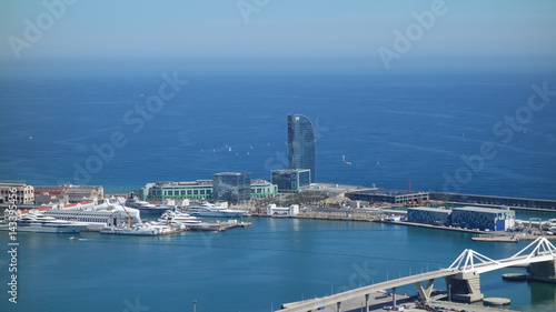 Barcelona-Spain. 28th March 2017 - View from Montjuic Castle over Port Vell and cruise-liner Azamara and W Barcelona, also known as the Hotel Vela (Sail Hotel). Lot of expensive luxury cruise ships