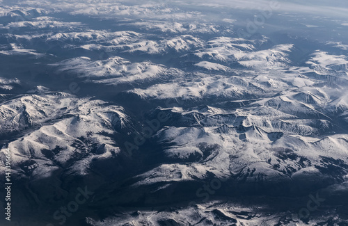 View from airplane on Earth surface - snow-capped mountains. © Vladimir Arndt