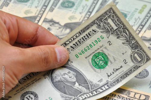 Man hand holding one dollar banknote 